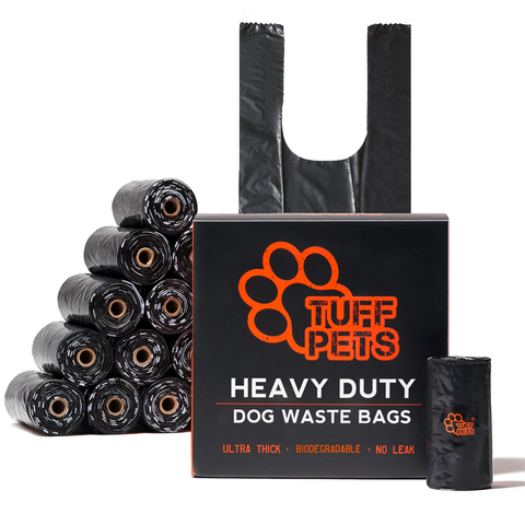 Tuff Pets Heavy Duty Dog Waste Bags box with stacked black rolls and a tie-handle bag: ultra thick, biodegradable, no leak